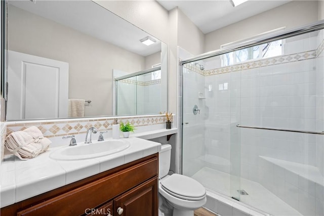 full bathroom with toilet, a stall shower, vanity, and backsplash