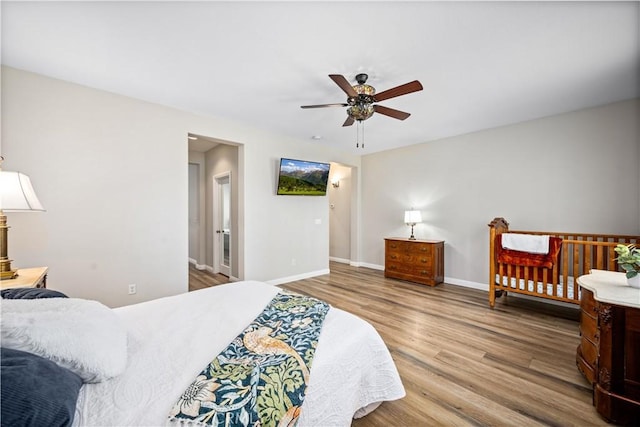 bedroom featuring wood finished floors, baseboards, and a ceiling fan