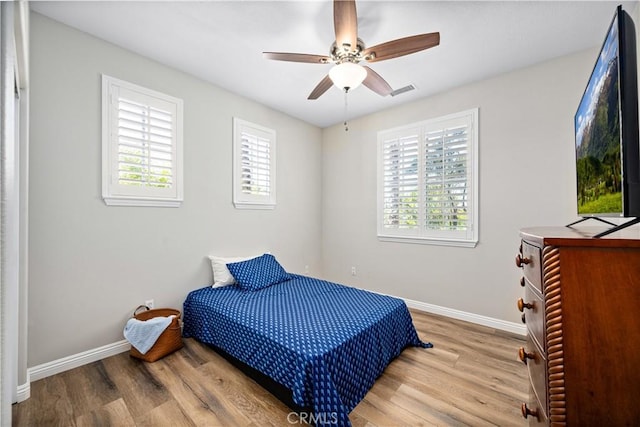 28264 Spring Creek Way, Menifee, CA 92585 - bedroom featuring multiple windows, wood finished floors, and baseboards