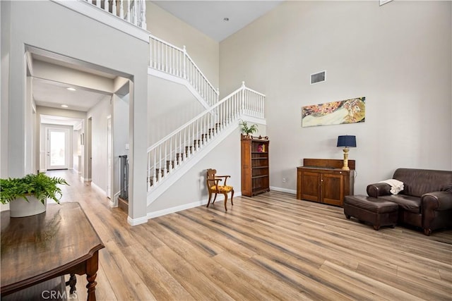 28264 Spring Creek Way, Menifee, CA 92585 - entrance foyer featuring stairway, a towering ceiling, light wood finished floors, and baseboards