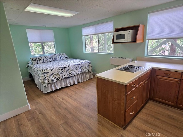 27403 Cottonwood Ln, Lake Arrowhead, CA 92317 - bedroom featuring baseboards, multiple windows, wood finished floors, and a drop ceiling