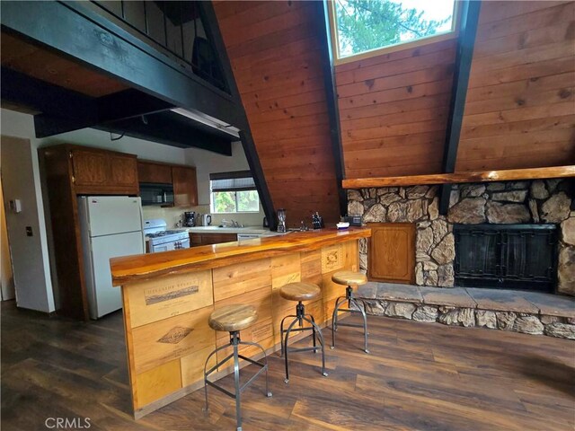 27403 Cottonwood Ln, Lake Arrowhead, CA 92317 - kitchen featuring white appliances, dark wood-type flooring, a peninsula, a skylight, and a fireplace
