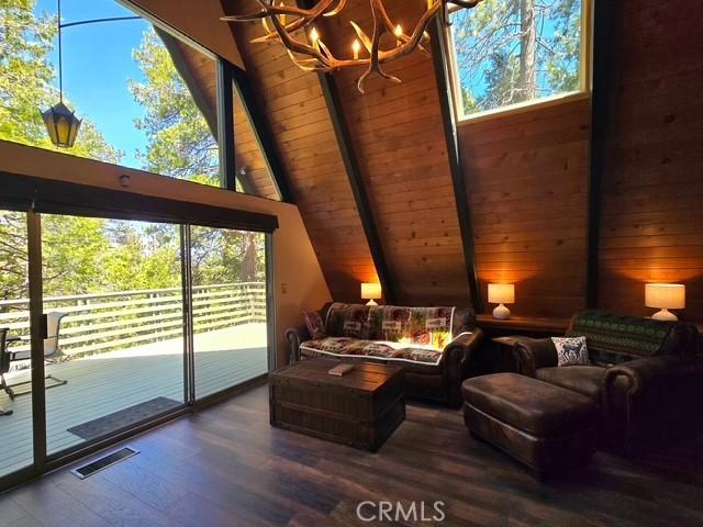 27403 Cottonwood Ln, Lake Arrowhead, CA 92317 - living area featuring a chandelier, wood ceiling, and wood finished floors