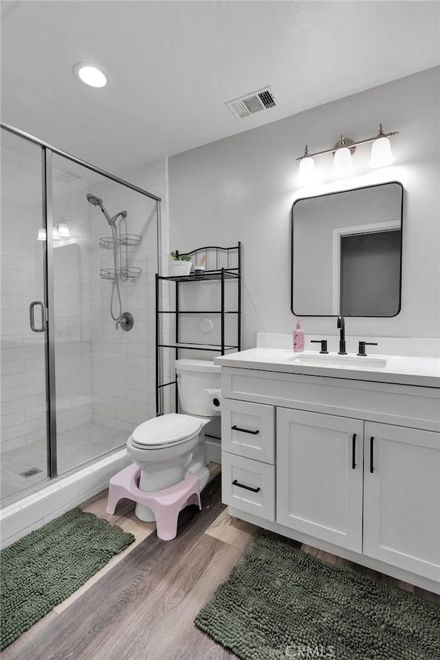 2612 Chauncy Pl, Riverside, CA 92506 - bathroom with wood finished floors, toilet, a stall shower, and vanity