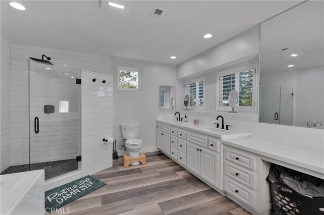 2612 Chauncy Pl, Riverside, CA 92506 - bathroom with a shower stall, recessed lighting, double vanity, wood finished floors, and toilet