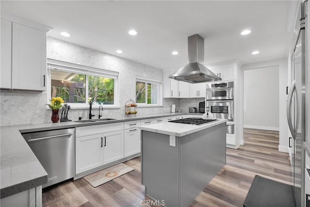 2612 Chauncy Pl, Riverside, CA 92506 - kitchen featuring island exhaust hood, stainless steel appliances, a sink, recessed lighting, and decorative backsplash