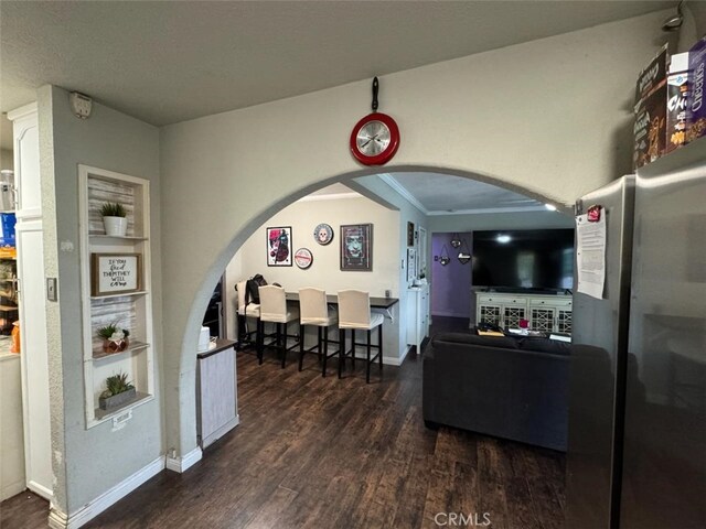 6045 Harding Ave, South Gate, CA 90280 - living area with wood finished floors, arched walkways, and baseboards
