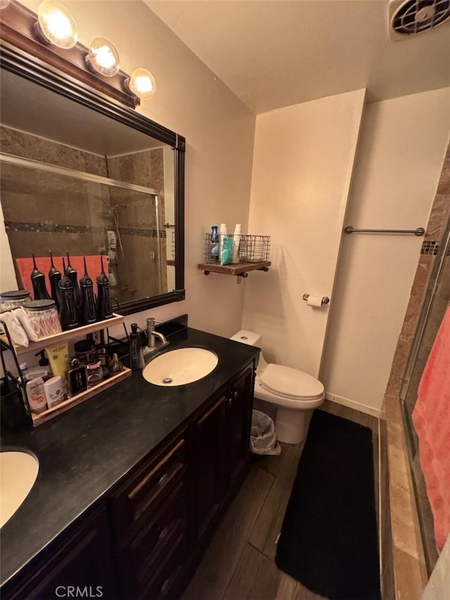 6045 Harding Ave, South Gate, CA 90280 - full bathroom with a stall shower, double vanity, and toilet