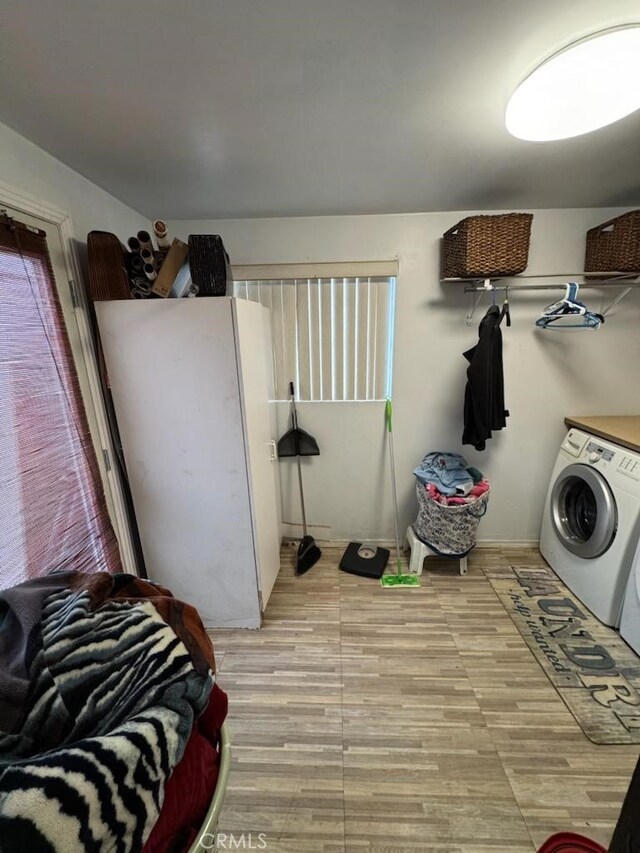 6045 Harding Ave, South Gate, CA 90280 - washroom with washer and dryer and light wood finished floors