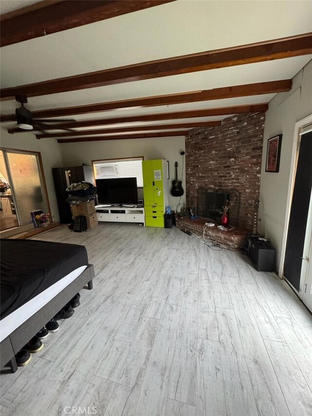 6045 Harding Ave, South Gate, CA 90280 - bedroom featuring beamed ceiling, wood finished floors, and a fireplace