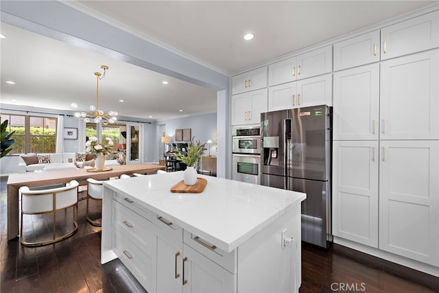 21 Fanpalm, Irvine, CA 92620 - kitchen featuring appliances with stainless steel finishes, dark wood finished floors, a center island, crown molding, and a chandelier
