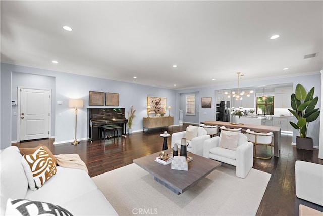 21 Fanpalm, Irvine, CA 92620 - living area with a chandelier, dark wood-type flooring, recessed lighting, baseboards, and crown molding