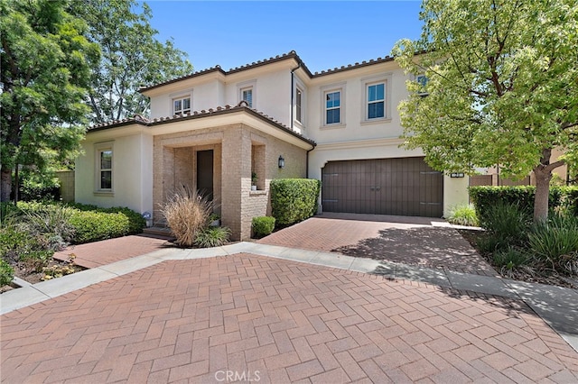 21 Fanpalm, Irvine, CA 92620 - mediterranean / spanish home featuring a garage, stucco siding, decorative driveway, and a tiled roof