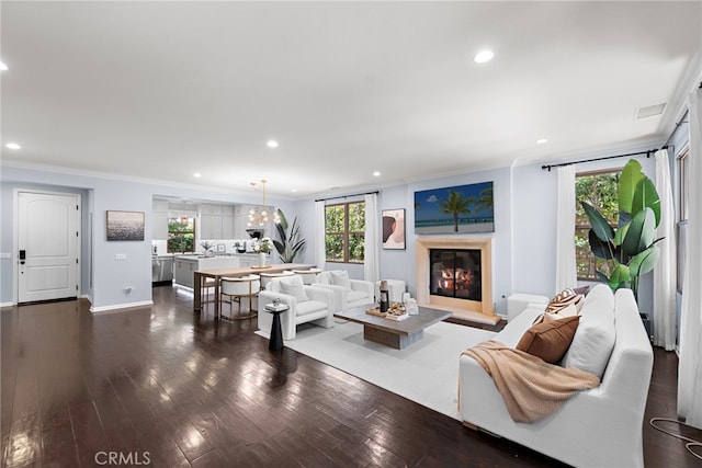 21 Fanpalm, Irvine, CA 92620 - living room with crown molding, recessed lighting, a glass covered fireplace, dark wood-type flooring, and baseboards