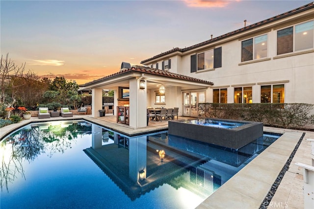 31740 Via Pamplona, San Juan Capistrano, CA 92675 - pool at dusk with an in-ground hot tub, an outdoor pool, a patio area, and french doors