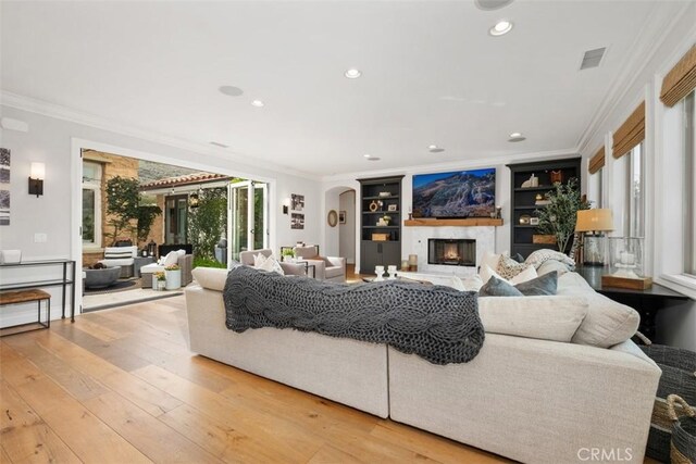 31740 Via Pamplona, San Juan Capistrano, CA 92675 - living room with crown molding, a fireplace, wood-type flooring, built in features, and recessed lighting