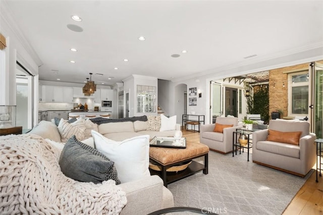 31740 Via Pamplona, San Juan Capistrano, CA 92675 - living room featuring arched walkways, light wood-style floors, recessed lighting, and crown molding