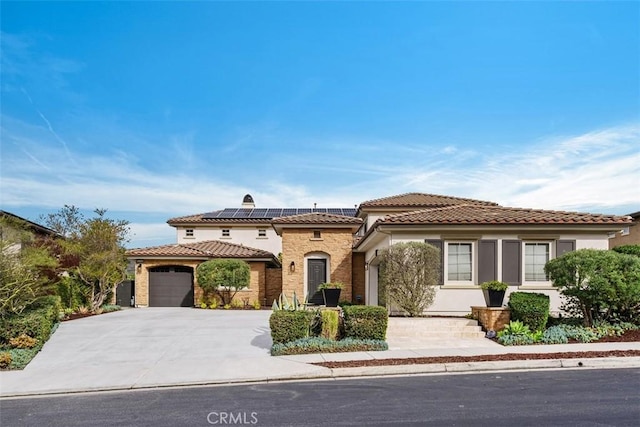 31740 Via Pamplona, San Juan Capistrano, CA 92675 - mediterranean / spanish-style home featuring an attached garage, stucco siding, a tile roof, and solar panels