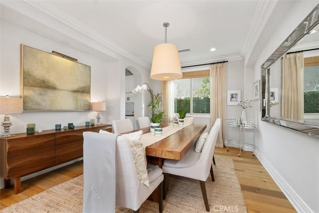 31740 Via Pamplona, San Juan Capistrano, CA 92675 - dining space featuring ornamental molding, arched walkways, light wood-style floors, baseboards, and recessed lighting