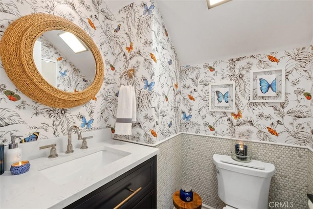 31740 Via Pamplona, San Juan Capistrano, CA 92675 - bathroom featuring wallpapered walls, a wainscoted wall, toilet, and vanity