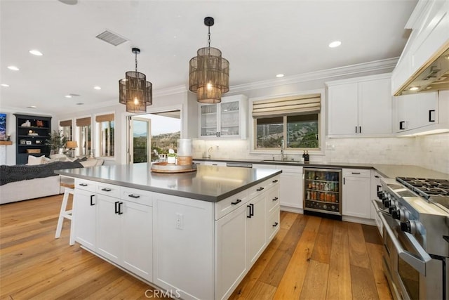 31740 Via Pamplona, San Juan Capistrano, CA 92675 - kitchen with beverage cooler, range with two ovens, a sink, open floor plan, and healthy amount of natural light