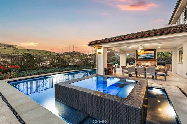 31740 Via Pamplona, San Juan Capistrano, CA 92675 - view of pool with an outdoor living space with a fireplace, a patio area, fence, and an in-ground hot tub