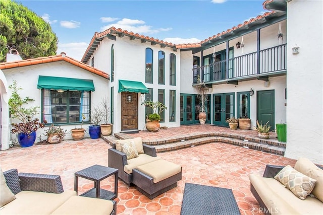 1585 E Ocean Blvd, Newport Beach, CA 92661 - rear view of property featuring french doors, stucco siding, a tile roof, and a patio
