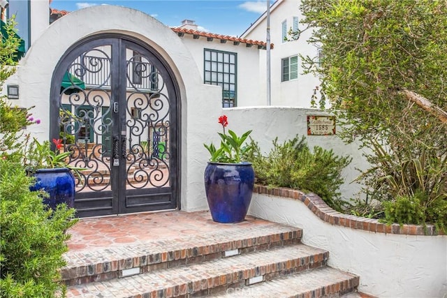 1585 E Ocean Blvd, Newport Beach, CA 92661 - doorway to property featuring stucco siding and a tile roof