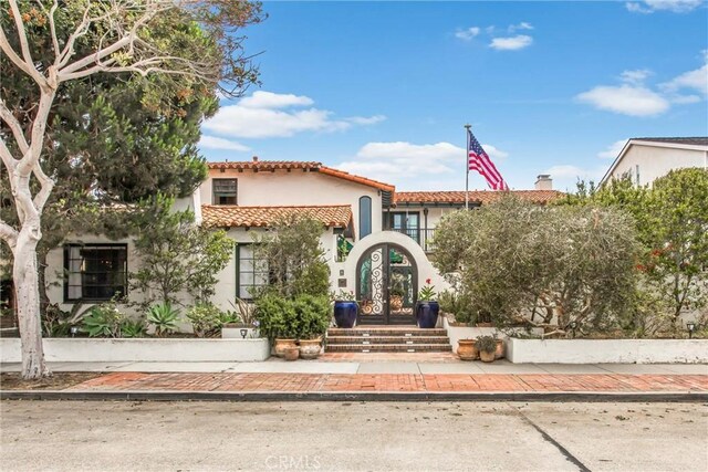1585 E Ocean Blvd, Newport Beach, CA 92661 - mediterranean / spanish house featuring stucco siding, a tile roof, and french doors