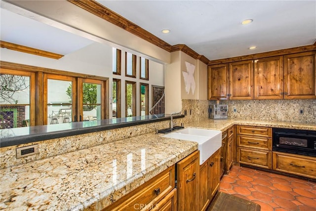 1585 E Ocean Blvd, Newport Beach, CA 92661 - kitchen with backsplash, brown cabinets, recessed lighting, light stone counters, and dark tile patterned floors