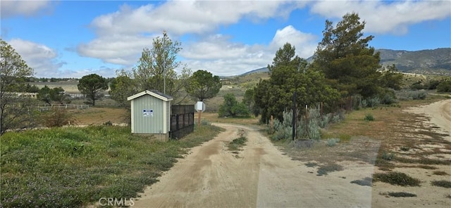 view of road with a mountain view and a view of rural / pastoral area