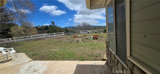 view of yard with a patio area and a mountain view