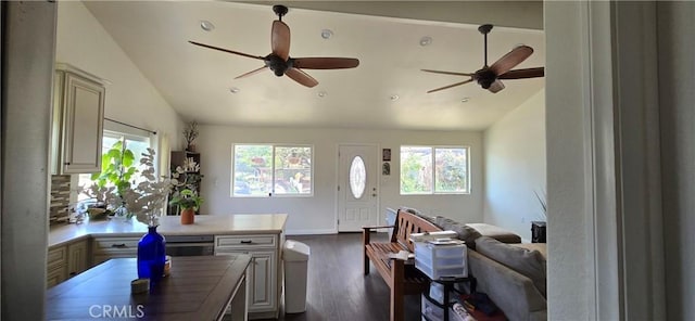 living area featuring vaulted ceiling, ceiling fan, plenty of natural light, dark wood-type flooring, and recessed lighting