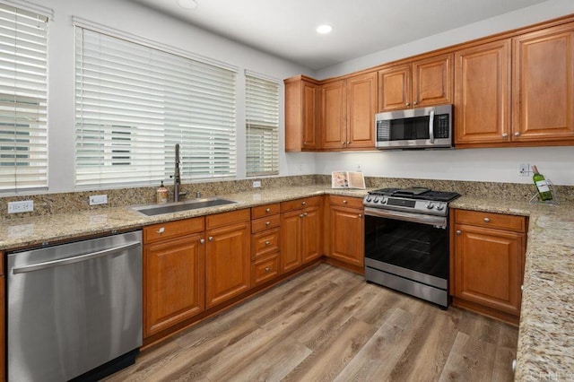 4918 Paramount Dr, San Diego, CA 92123 - kitchen with appliances with stainless steel finishes, a sink, light wood-style floors, recessed lighting, and brown cabinetry