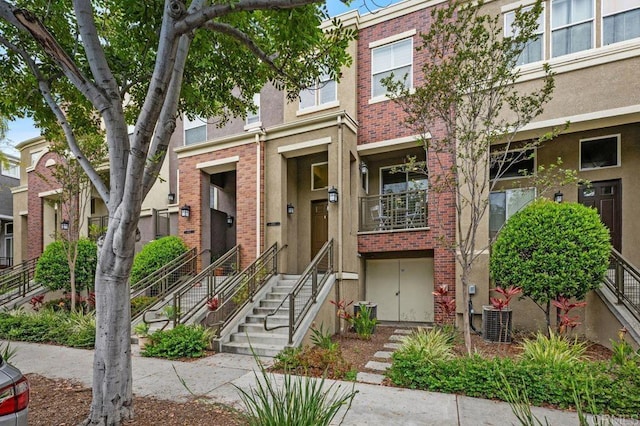 4918 Paramount Dr, San Diego, CA 92123 - view of property with central AC, brick siding, and stucco siding