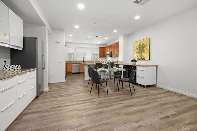 4918 Paramount Dr, San Diego, CA 92123 - kitchen featuring appliances with stainless steel finishes, brown cabinetry, baseboards, recessed lighting, and light wood-style floors