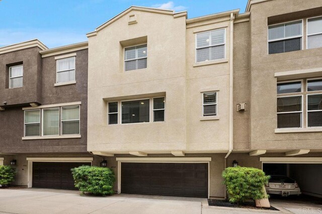 4918 Paramount Dr, San Diego, CA 92123 - view of property with an attached garage, stucco siding, and driveway