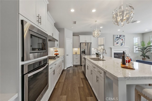 4530 E Langdon Dr, Anaheim Hills, CA 92807 - kitchen featuring stainless steel appliances, a sink, a chandelier, white cabinetry, and a spacious island
