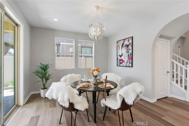 4530 E Langdon Dr, Anaheim Hills, CA 92807 - dining space with light wood-style flooring, arched walkways, a chandelier, baseboards, and recessed lighting