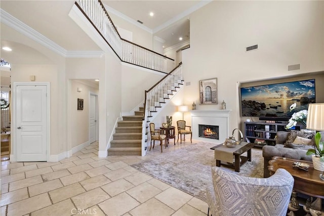 23478 Ridgeway, Mission Viejo, CA 92692 - living room featuring stairs, ornamental molding, a lit fireplace, a high ceiling, and baseboards