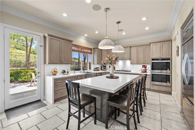 23478 Ridgeway, Mission Viejo, CA 92692 - kitchen featuring appliances with stainless steel finishes, plenty of natural light, light countertops, a kitchen bar, and crown molding