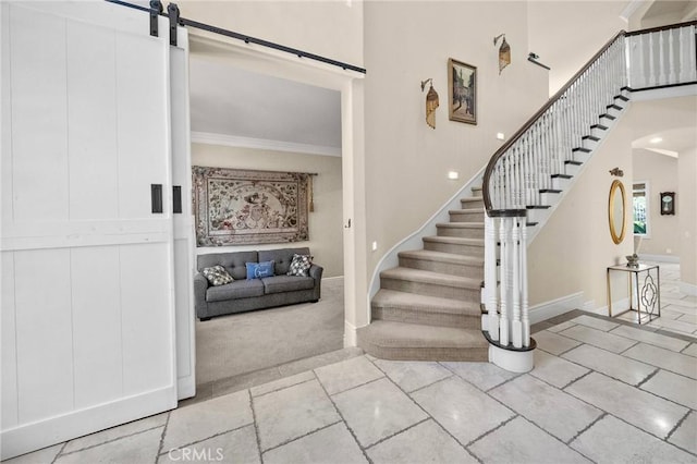 23478 Ridgeway, Mission Viejo, CA 92692 - staircase with crown molding, baseboards, a barn door, a high ceiling, and carpet floors