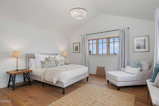 101 Via Tusa, Santa Barbara, CA 93105 - bedroom featuring a chandelier, wood finished floors, and high vaulted ceiling