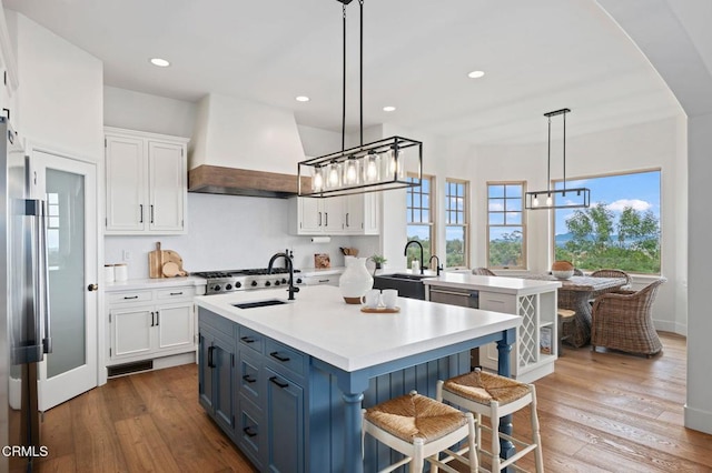 101 Via Tusa, Santa Barbara, CA 93105 - kitchen featuring a chandelier, white cabinetry, a sink, light countertops, and a kitchen island with sink