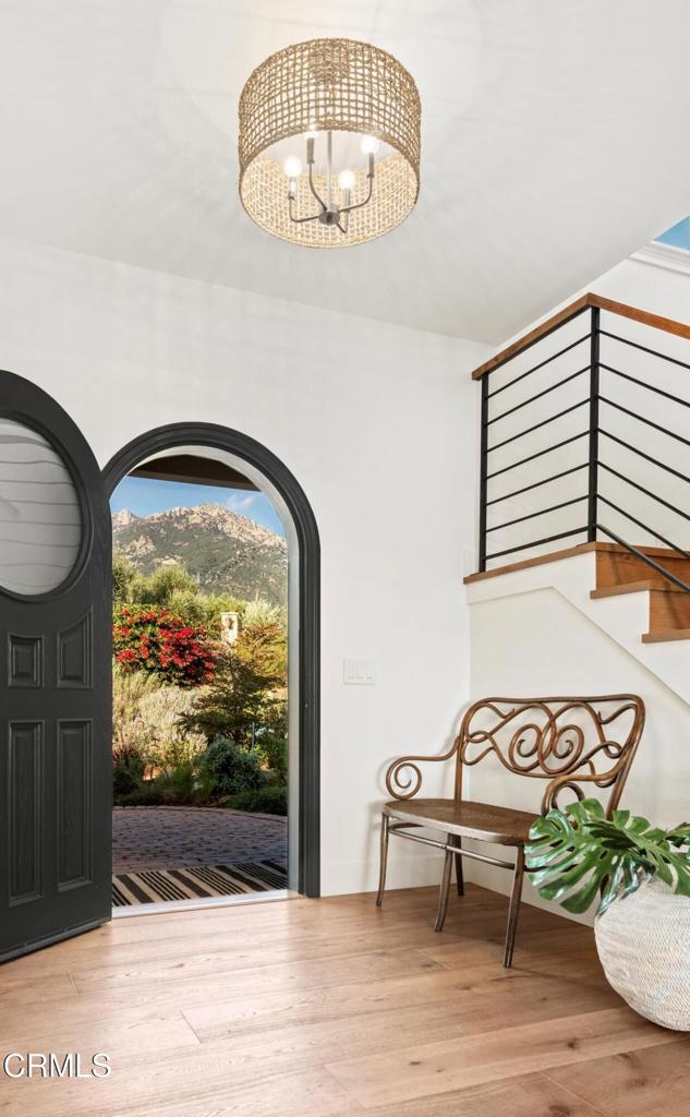 101 Via Tusa, Santa Barbara, CA 93105 - entrance foyer featuring a chandelier, stairs, and wood finished floors