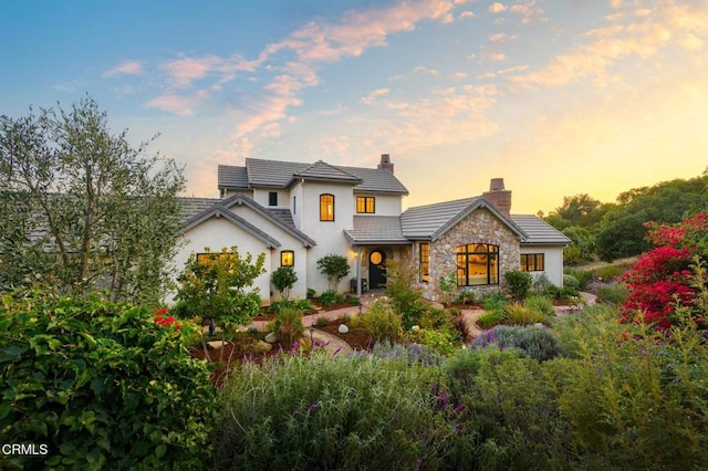 101 Via Tusa, Santa Barbara, CA 93105 - view of front of house with a chimney, stone siding, stucco siding, and a tiled roof