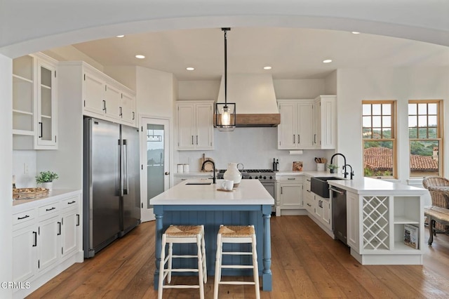 101 Via Tusa, Santa Barbara, CA 93105 - kitchen with premium appliances, custom exhaust hood, light countertops, a sink, and recessed lighting