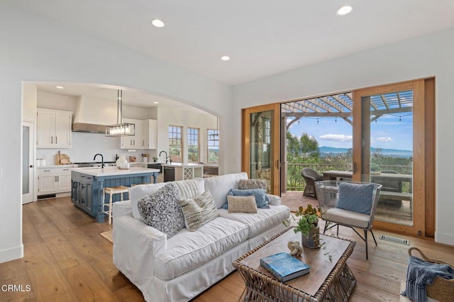 101 Via Tusa, Santa Barbara, CA 93105 - living room with hardwood / wood-style flooring, recessed lighting, arched walkways, and baseboards