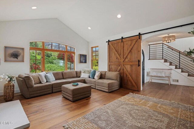 101 Via Tusa, Santa Barbara, CA 93105 - living area featuring a barn door, hardwood / wood-style floors, high vaulted ceiling, stairs, and recessed lighting