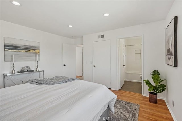 bedroom with light wood-style floors, recessed lighting, and baseboards